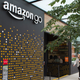 A woman walks past the Amazon Go grocery store at the Amazon corporate headquarters on June 16 in Seattle.